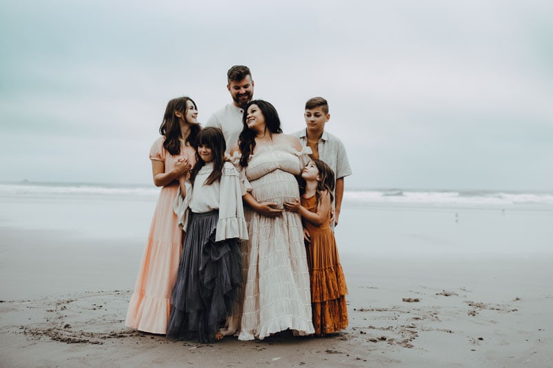 mom surrounded by her kids and husband during session with Oregon Coast family Photographer