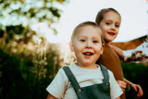Portland Family photography, two sibling children smile as they stand outside