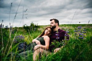 Family Photography, woman leans back on her husband in a grassy field