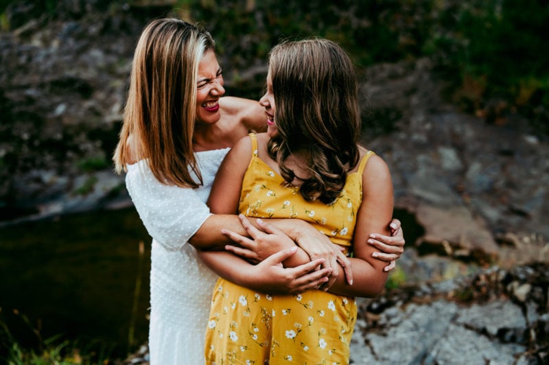 mother and daughter embracing and smiling at each other