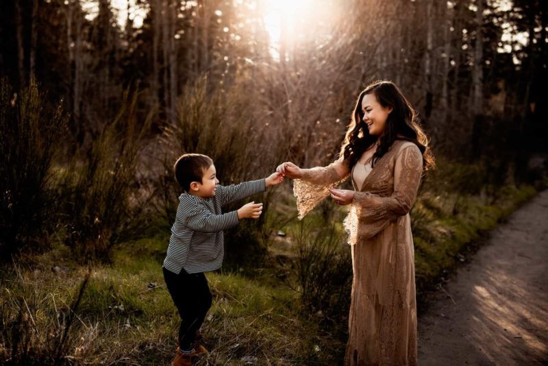 son gives mother a flower in a park in Portland, OR