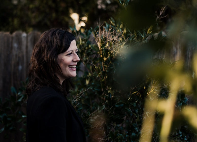 Portland mom smiling in a garden