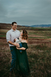 Portland Newborn Photographer, couple standing with newborn baby in field