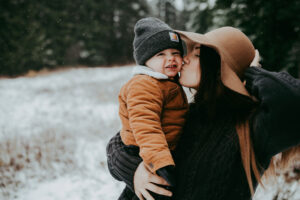 mom kissing toddler during family photos in Mt Hood