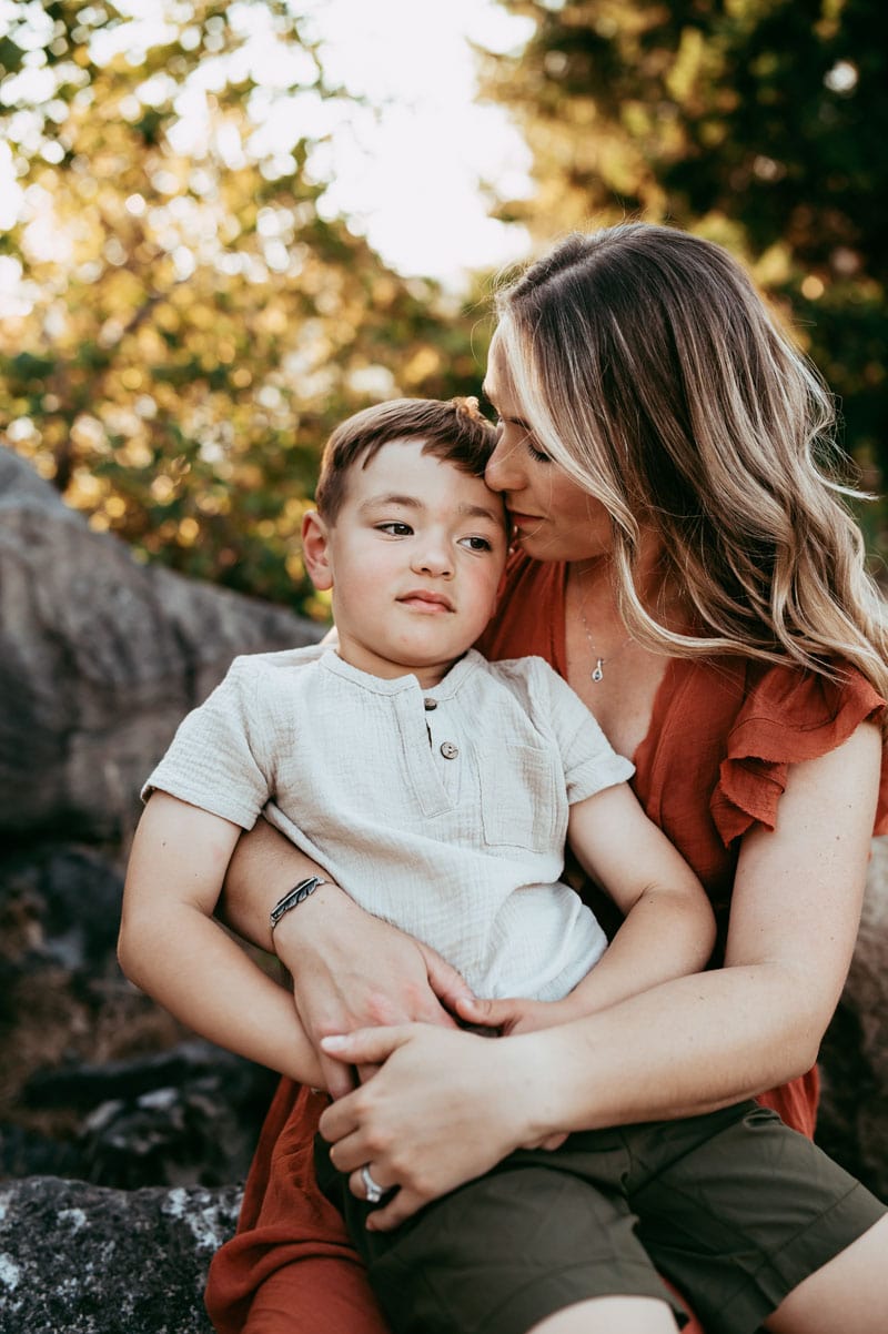 mom kissing son on the head during family session
