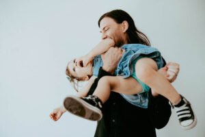 father and daughter spinning during photoshoot for birthday party ideas in Portland