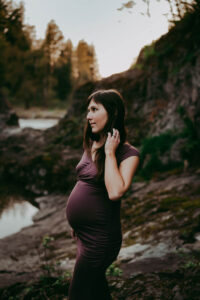pregnant woman during maternity session in oregon wearing a purple dress
