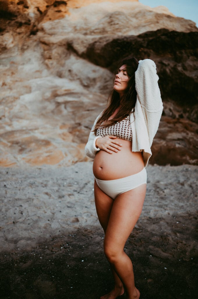 pregnant woman posing for portland motherhood and family photographer